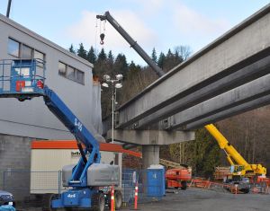 The Evergreen rapid transit line under construction, passing within a few metres of the Andres industrial building on the edge of downtown Port Moody