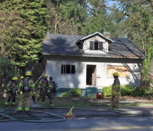 A boarded-up house east of Pinetree, one of a row waiting for redevelopment. On the day of our tour, someone had set fire to the house.