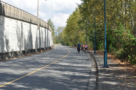 Argue Street, closed to through vehicle traffic, under the embankment of provincial highway 7B. The Fraser River is on the right.