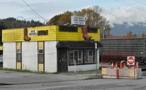 Vintage commercial building at new construction, west of Moody Centre station