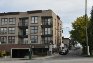 New residences built in anticipation of Skytrain with faux-vintage laneway commercial behind, Moody Centre
