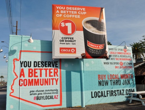 A wall graphic on an established building urges residents to 